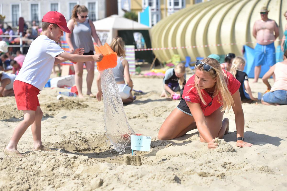 SPLASH: Gina Hartley helps five-year-old Riley Marsdon in the sandcastle competition
