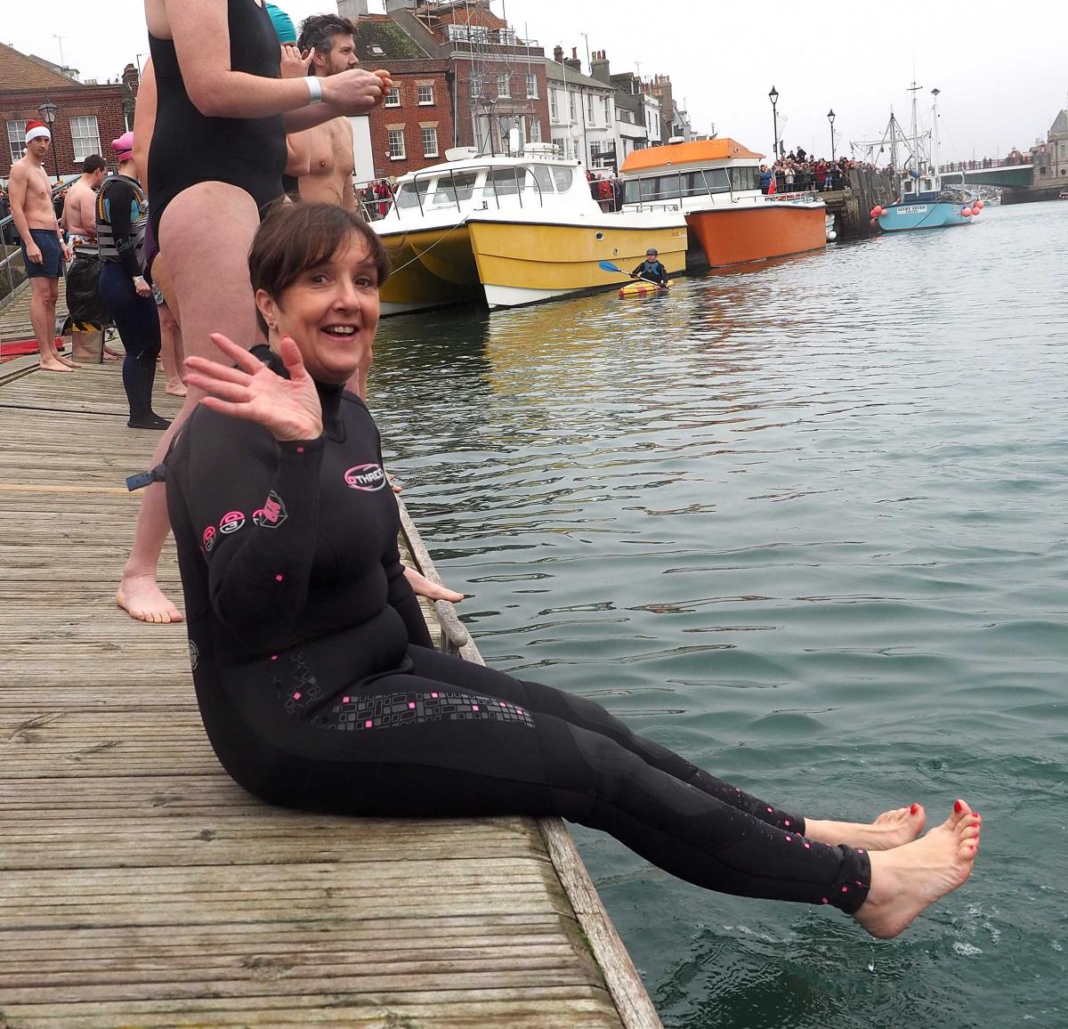 GOOD CAUSE: Swimmers jump in to the harbour