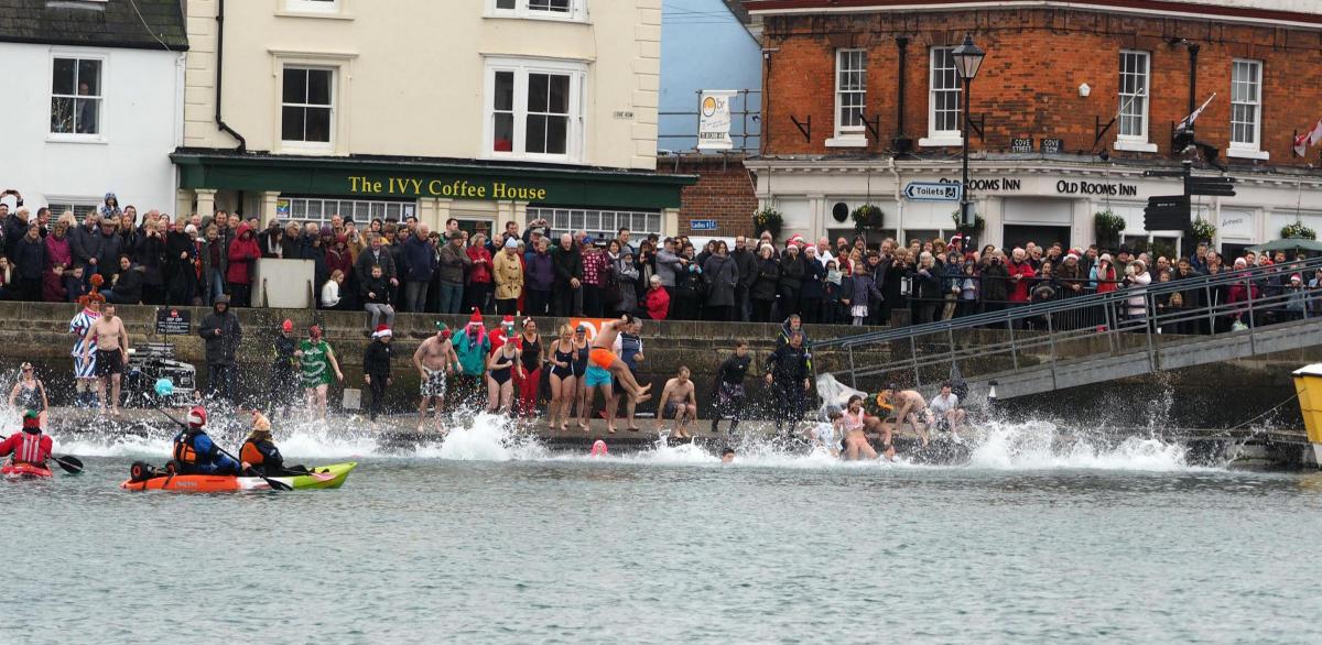 GOOD CAUSE: Swimmers jump in to the harbour