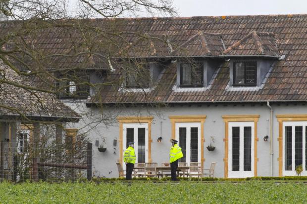 Dorset Echo: Police officers in the back garden of the house Picture: Graham Hunt/BNPS