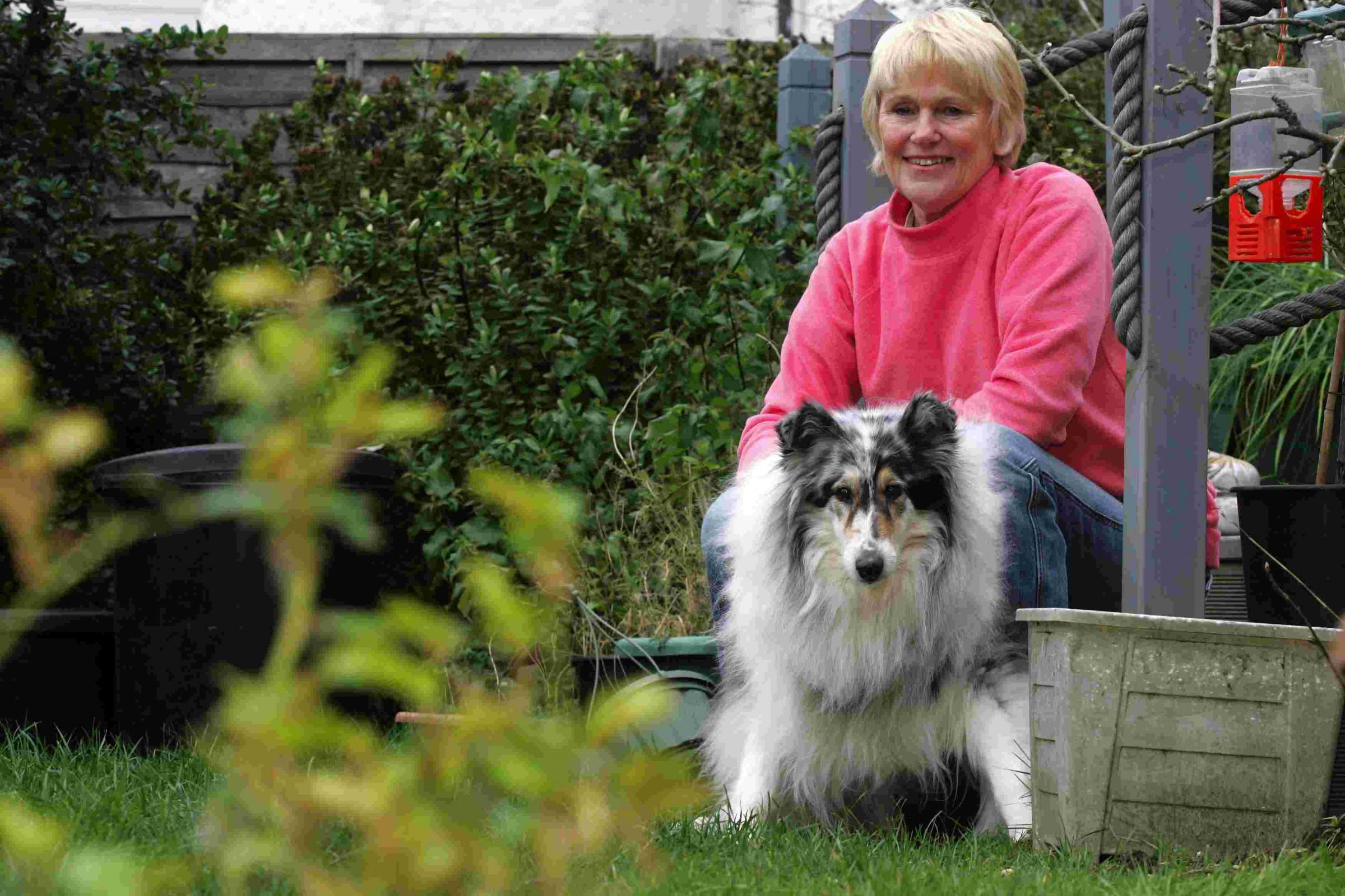 Pic by Sally Adams 18/3/08 bIgcat2 Pam Skilton with her dog Sadie in her garden where she saw the big cat.
