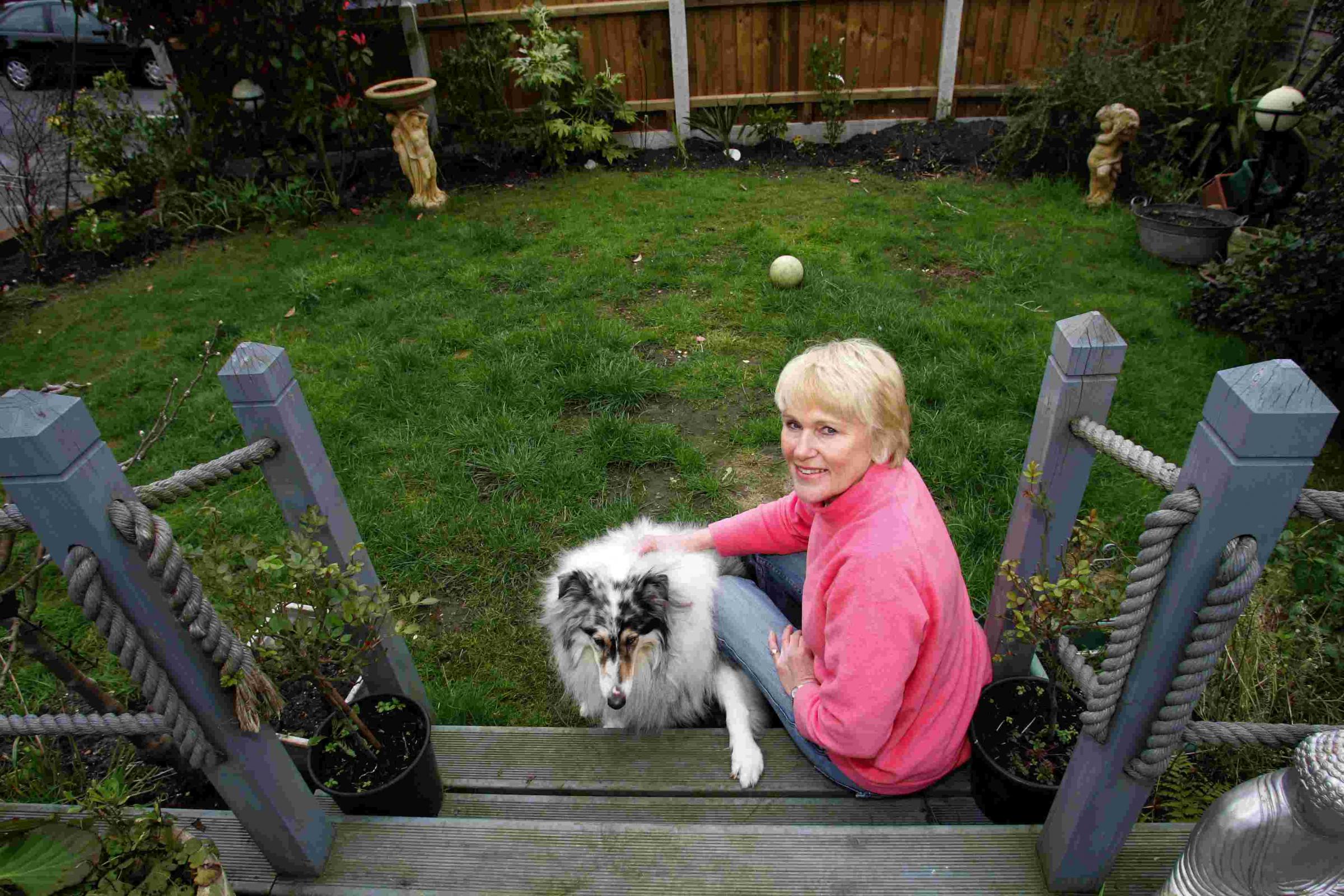 Pic by Sally Adams 18/3/08 bIgcat3 Pam Skilton with her dog Sadie in her garden where she saw the big cat.