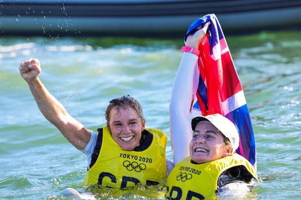 Hannah Mills, left, and Eilidh McIntyre celebrate in the water after winning gold at Tokyo 2020 Picture: SAILING ENERGY/WORLD SAILING