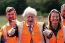 Prime Minister Boris Johnson (centre) during a visit to Henbury Farm in north Dorset, where Wessex Internet are laying fibre optics in the field. His visit marks new data showing that 70 percent of the UK is now benefiting from gigabit broadband