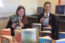 Student librarians Kitty and Amber holding books from the Buy a Book appeal. Image: Kate Shelley