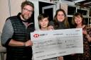 Owners of the Brewers Arms, Martinstown, Leanne and Ben Carter with one of their sons and Roelie Newman, Martinstown Circle Supper Committee Member holding the cheque for £7.9k raised for the charity Living with Cah