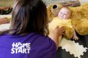 A Home-Start volunteer with a baby