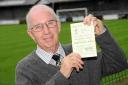 DOWN MEMORY LANE: Dorchester Town club historian Melvin Cross with a programme from the 1957 FA Cup meeting between Dorchester and Plymouth, which was played at Home Park