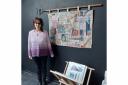 Ali Mauger with her hand stitched boro quilt, made with antique fabrics, hanging from a 1930's garden hoe