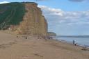 Beachgoers at West Bay on Sunday evening - two hours later the cliff collapsed