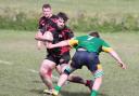 Puddletown cup captain Rhys Jenner, left, on the attack against North Dorset