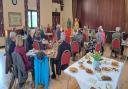 Volunteers gather for teas and coffees at Artsreach's celebration event