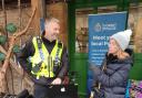 A police officer in Sherborne speaking to a member of the public about crime priorities in the area