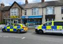 Shop cordoned off in armed police probe