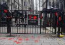 The protesters poured fake blood over the gates of Downing Street