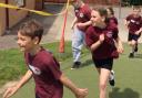 Children running round the school field