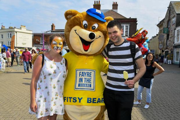 Dorset Echo: Weymouth Fayre in the Square.  Becky Owen and Harry Ward with Fitsy Bear.  26th May 2018.  Picture Credit: Graham Hunt Photography.