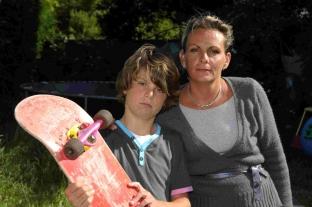 Issac Rogers with his mum Joanna and his damaged skateboard