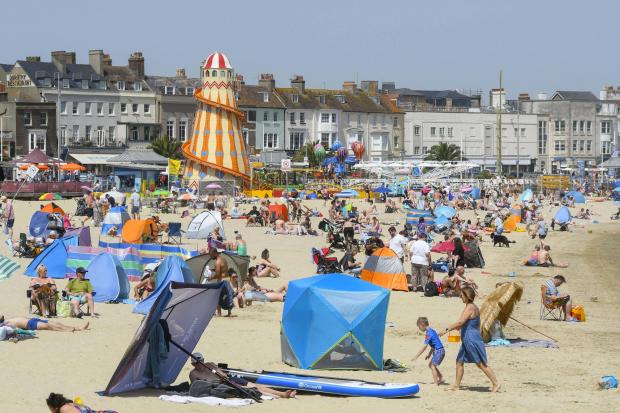 Dorset Echo: Sunbathers and families pack the beach as they enjoy the scorching hot sunshine at Weymouth.  17th June 2022.  Picture Credit: Graham Hunt Photography