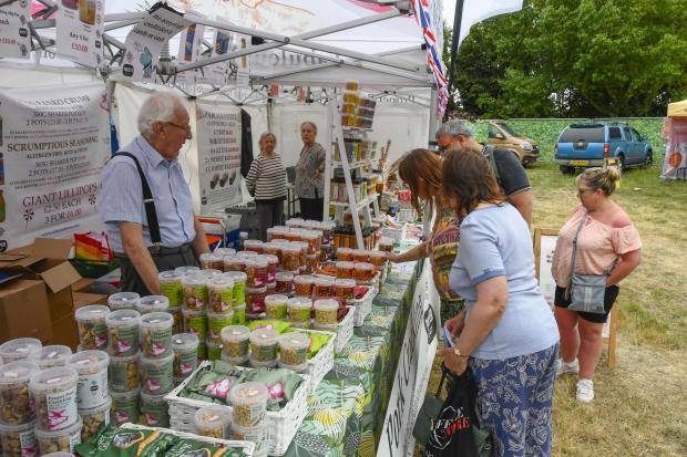 Dorset Echo: Visitors looking at the stalls at the Weymouth food festival at Lodmoor Country Park.  30th July 2022.  Picture Credit: Graham Hunt Photography