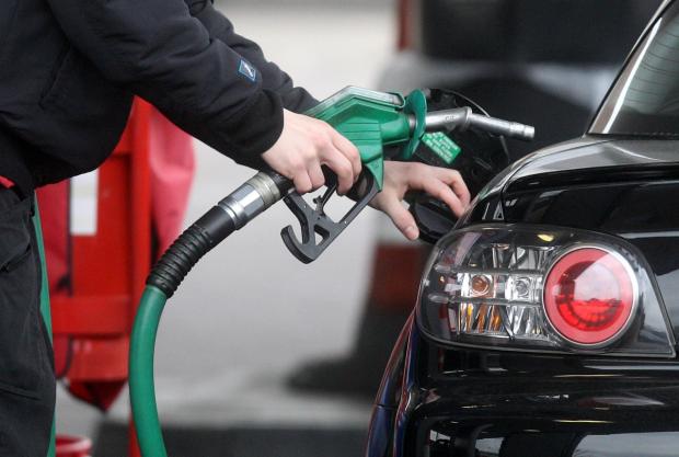 Dorset Echo: Someone using a fuel pump at a petrol station (PA)