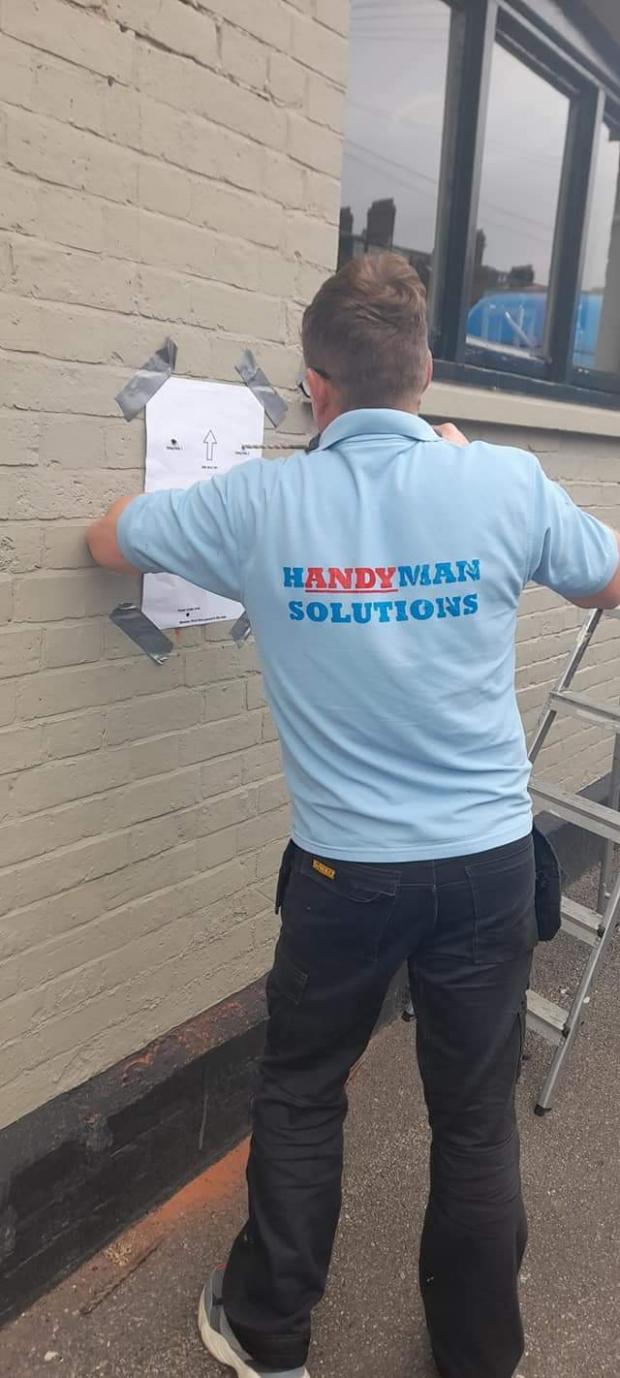 Dorset Echo: The defibrillator is installed free of charge by Andy Lambart of Handyman Solutions.  Photo: Ricky Cleverley
