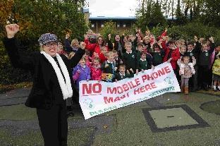 THAT’S GOOD NEWS: School governor Helen Toft with parents and children at Holy Trinity School celebrate after the withdrawal of the mobile phone mast plan
