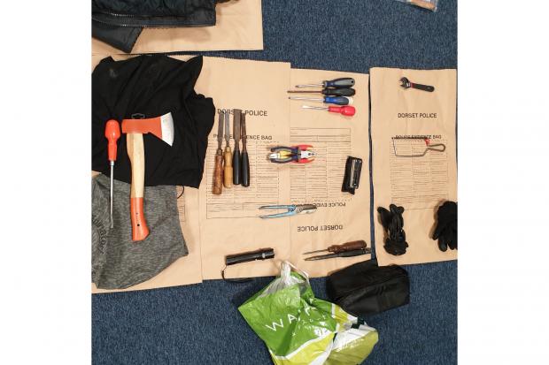 Items including a saw, axe and screwdrivers were recovered by police