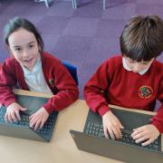 Lulworth and Winfrith C of E Primary School pupils using laptops