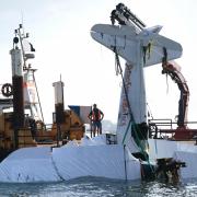 The plane is lifted from the water on Sunday, September 5