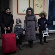 A family who fled the war from neighboring Ukraine arrive to the Przemysl train station in Przemysl, Poland, Wednesday, March 9, 2022. (AP Photo/Daniel Cole).