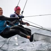 Charlotte Dobson and Saskia Tidey of Great Britain in action at the finish of a 49erFX class race. (Photo by Clive Mason/Getty Images).