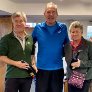 Tournament champions Chris Porter, left, and Laura Dodington, right, receiving their prizes from chairman Al Clark.