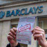 Protestors presented letters and covered the bank in stickers