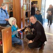 Father Anthony O'Gorman with one of the special visitors attending the pet service at Our Lady Star of the Sea church in Weymouth
