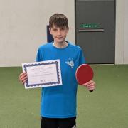 Daniel Scotchmer with a certificate following his win in the under-19 consolation final at Horsham.
