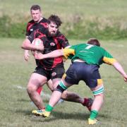Puddletown cup captain Rhys Jenner, left, on the attack against North Dorset