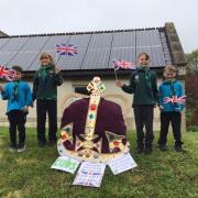 CORONATION celebrations in a Dorset village are in full swing as an exact replica of King Charles' coronation crown goes on display.