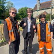 Trainspotter Francis Bourgeois (middle) was at Corfe Castle station on Sunday where he posed for pictures with fellow railway enthusiasts. Also pictured: Swanage Railway volunteers George Miller (left) and Sam Smith (right).