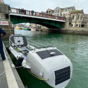The rowing boat was towed to a waiting pontoon in Weymouth