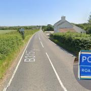 The coast road has been closed following a two-vehicle crash