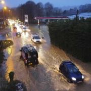 Vehicles making their way through the sodden roads in Winterborne Abbas