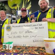 Club president Ryan Hope with Lions Kevin Brookes and Trevor Stratton are seen pictured at the Weymouth ASDA Supermarket with the cheque.