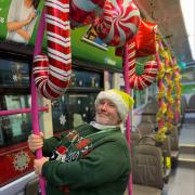 Supervisor Ricki Frost on board festive bus decorated with balloons and tinsel