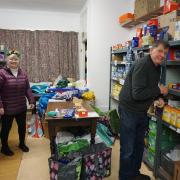 Volunteers moving food from the bank's store room