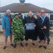 Blue Balls Weymouth founder Graham Foster with fellow swimmers after completing cold water swim