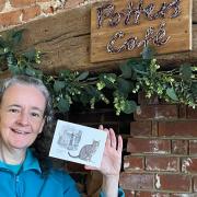Catherine Owen with her new postcard to honour Susie the cat