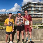Weymouth Bay 10k winner Shaun Dixon, centre, with George Mallinson, right, and Cory Stone