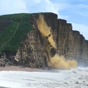 This video shows the dramatic moment tonnes of rock fell from the cliff at West Bay