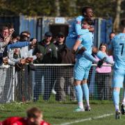 Shaq Gwengwe, top, celebrates Dorchester's goal at Winchester